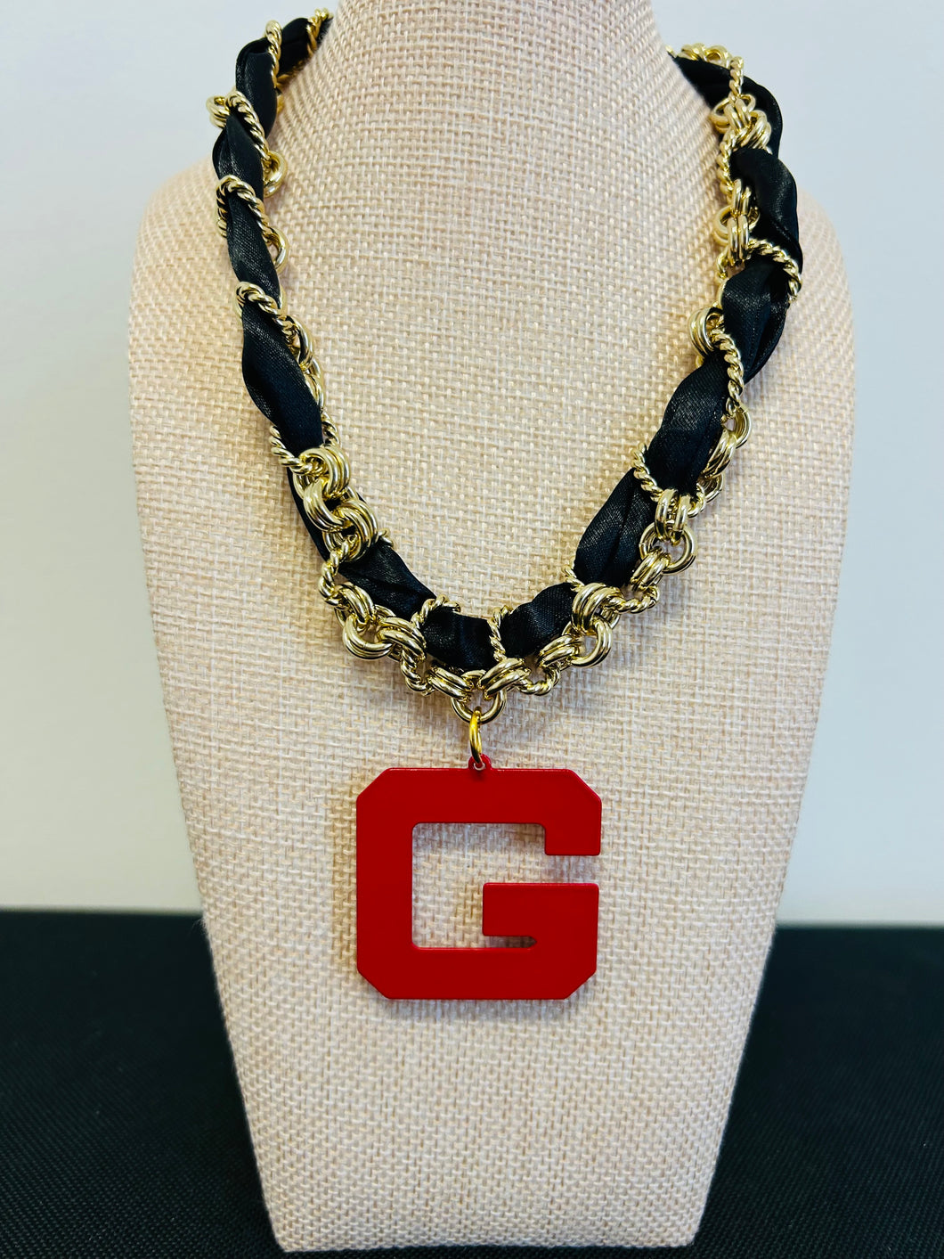 Red G with gold and black chain necklace